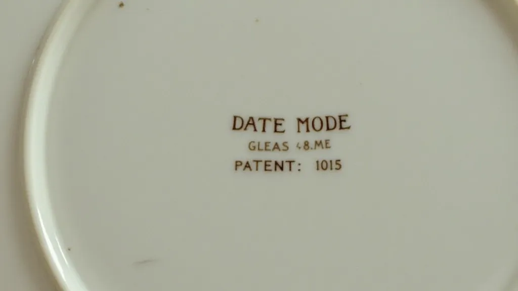 A close-up view of a date code and patent date on glass